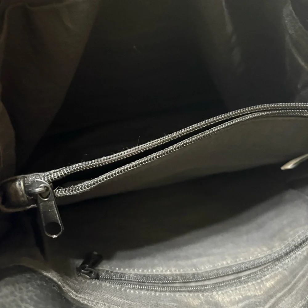 Black tote bag with a tassel accent. - Picture 6 of 12